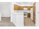 Bright kitchen with wood cabinets and white appliances at 5155 W Tropicana Ave # 2123, Las Vegas, NV 89103