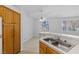 View of kitchen sink and cabinets from dining area at 5155 W Tropicana Ave # 2123, Las Vegas, NV 89103