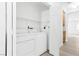 Bright laundry room with washer and dryer, shelving and easy access at 5155 W Tropicana Ave # 2123, Las Vegas, NV 89103