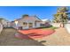 Artificial turf and red brick backyard patio at 5306 Falling Petals Dr, North Las Vegas, NV 89031