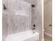 Clean bathroom with a shower/tub combo and modern tile at 5306 Falling Petals Dr, North Las Vegas, NV 89031