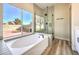 Main bathroom with soaking tub, glass shower, and modern fixtures at 5306 Falling Petals Dr, North Las Vegas, NV 89031