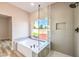 Modern bathroom with soaking tub, glass shower, and gray tile at 5306 Falling Petals Dr, North Las Vegas, NV 89031