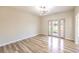 Bright bedroom with french doors leading to backyard and wood-look floors at 5306 Falling Petals Dr, North Las Vegas, NV 89031