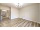 Spacious bedroom with wood-look floors and access to hallway at 5306 Falling Petals Dr, North Las Vegas, NV 89031