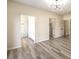 Bedroom with wood-look floors and access to closets and bath at 5306 Falling Petals Dr, North Las Vegas, NV 89031