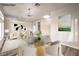 Bright dining area with a glass-top table and modern light fixture at 5306 Falling Petals Dr, North Las Vegas, NV 89031