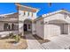 Front view of the house, featuring a walkway and two-car garage at 5306 Falling Petals Dr, North Las Vegas, NV 89031