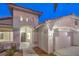 Well-lit entryway with arched doorway and access to a two-car garage at 5306 Falling Petals Dr, North Las Vegas, NV 89031