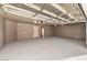 Attached garage with open ceiling and painted floor at 5306 Falling Petals Dr, North Las Vegas, NV 89031