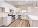 Modern kitchen with white shaker cabinets, quartz countertops, and stainless steel appliances at 5306 Falling Petals Dr, North Las Vegas, NV 89031