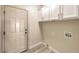 Laundry room with white cabinets and vinyl flooring at 5306 Falling Petals Dr, North Las Vegas, NV 89031