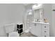 Updated bathroom with white vanity, modern fixtures, and a toilet at 5420 Doe Ave, Las Vegas, NV 89146