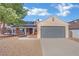 Single-story home with grey garage door and landscaped yard at 5420 Doe Ave, Las Vegas, NV 89146