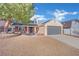 Single-story home with grey garage door and landscaped yard at 5420 Doe Ave, Las Vegas, NV 89146