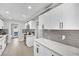 Stylish kitchen featuring white shaker cabinets and a gray tile backsplash at 5420 Doe Ave, Las Vegas, NV 89146