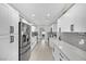 Modern kitchen with white cabinets, gray backsplash, and stainless steel appliances at 5420 Doe Ave, Las Vegas, NV 89146