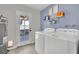 Bright laundry room with washer, dryer, and exterior access at 5420 Doe Ave, Las Vegas, NV 89146