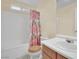 Clean bathroom with a shower/tub combo and floral shower curtain at 5533 Ramirez St, North Las Vegas, NV 89031