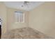 Well-lit bedroom featuring tile floors and a ceiling fan at 5533 Ramirez St, North Las Vegas, NV 89031