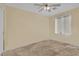 Bright bedroom with tile flooring, ceiling fan, and window coverings at 5533 Ramirez St, North Las Vegas, NV 89031