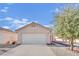 Single-story house with a white garage door and landscaped yard at 5533 Ramirez St, North Las Vegas, NV 89031