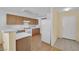 Kitchen with wood cabinets, white appliances and a view of the dining area at 5533 Ramirez St, North Las Vegas, NV 89031