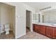 Bathroom boasts double sinks, wood cabinets, and a separate toilet area for added privacy at 5636 Granville Lake St, North Las Vegas, NV 89031