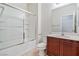 Bright bathroom features a shower-tub combo with white tile surround and a single sink vanity at 5636 Granville Lake St, North Las Vegas, NV 89031