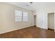 Bedroom with neutral carpet, two windows, and double door closet provide ample storage space at 5636 Granville Lake St, North Las Vegas, NV 89031