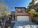 Inviting two-story home featuring a two-car garage and low maintenance desert landscaping at 5636 Granville Lake St, North Las Vegas, NV 89031