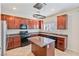 Well-equipped kitchen with granite countertops, stainless steel appliances, and central island at 5636 Granville Lake St, North Las Vegas, NV 89031