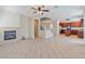 Spacious open-concept living room with fireplace, adjacent to kitchen, and staircase at 5636 Granville Lake St, North Las Vegas, NV 89031