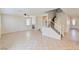 Open-concept living room with fireplace, tile floors, and staircase leading to the upper level at 5636 Granville Lake St, North Las Vegas, NV 89031