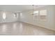 Bright living room with tile flooring, entry door, and a modern chandelier at 5636 Granville Lake St, North Las Vegas, NV 89031