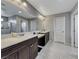 Double vanity bathroom with dark brown cabinets and shower at 5658 Adobe Jack St, North Las Vegas, NV 89031