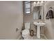 Small bathroom with pedestal sink and toilet at 5658 Adobe Jack St, North Las Vegas, NV 89031