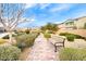 Landscaped community walkway with a bench at 5658 Adobe Jack St, North Las Vegas, NV 89031