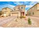 Two-story house with a landscaped front yard and attached garage at 5658 Adobe Jack St, North Las Vegas, NV 89031