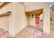 Home's front entrance with a covered porch and red door at 5658 Adobe Jack St, North Las Vegas, NV 89031