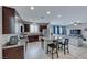 Open concept kitchen with island, stainless steel appliances, and view to living room at 5658 Adobe Jack St, North Las Vegas, NV 89031