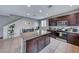 Modern kitchen with island and dark brown cabinets at 5658 Adobe Jack St, North Las Vegas, NV 89031