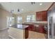 Kitchen features island, stainless steel appliances, and dark wood cabinets at 5744 Serenity Haven St, North Las Vegas, NV 89081