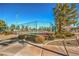 Well-maintained tennis courts with surrounding landscaping and a shaded seating area at 5744 Serenity Haven St, North Las Vegas, NV 89081