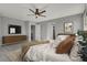 Virtually staged main bedroom with king bed, dresser, and TV at 5921 Roaring Canyon Ct, Las Vegas, NV 89139