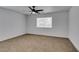 Simple bedroom with light walls, ceiling fan and carpet at 5934 Clear Valley Ave, Las Vegas, NV 89142