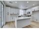 Modern kitchen with white cabinets, center island, and access to backyard at 5934 Clear Valley Ave, Las Vegas, NV 89142