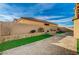 Landscaped backyard with artificial turf and a water feature at 5969 Viscaya Grove St, Las Vegas, NV 89118