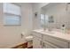 Clean and modern bathroom with white vanity and a large mirror at 5969 Viscaya Grove St, Las Vegas, NV 89118