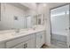 Double vanity bathroom with white cabinets and separate tub at 5969 Viscaya Grove St, Las Vegas, NV 89118